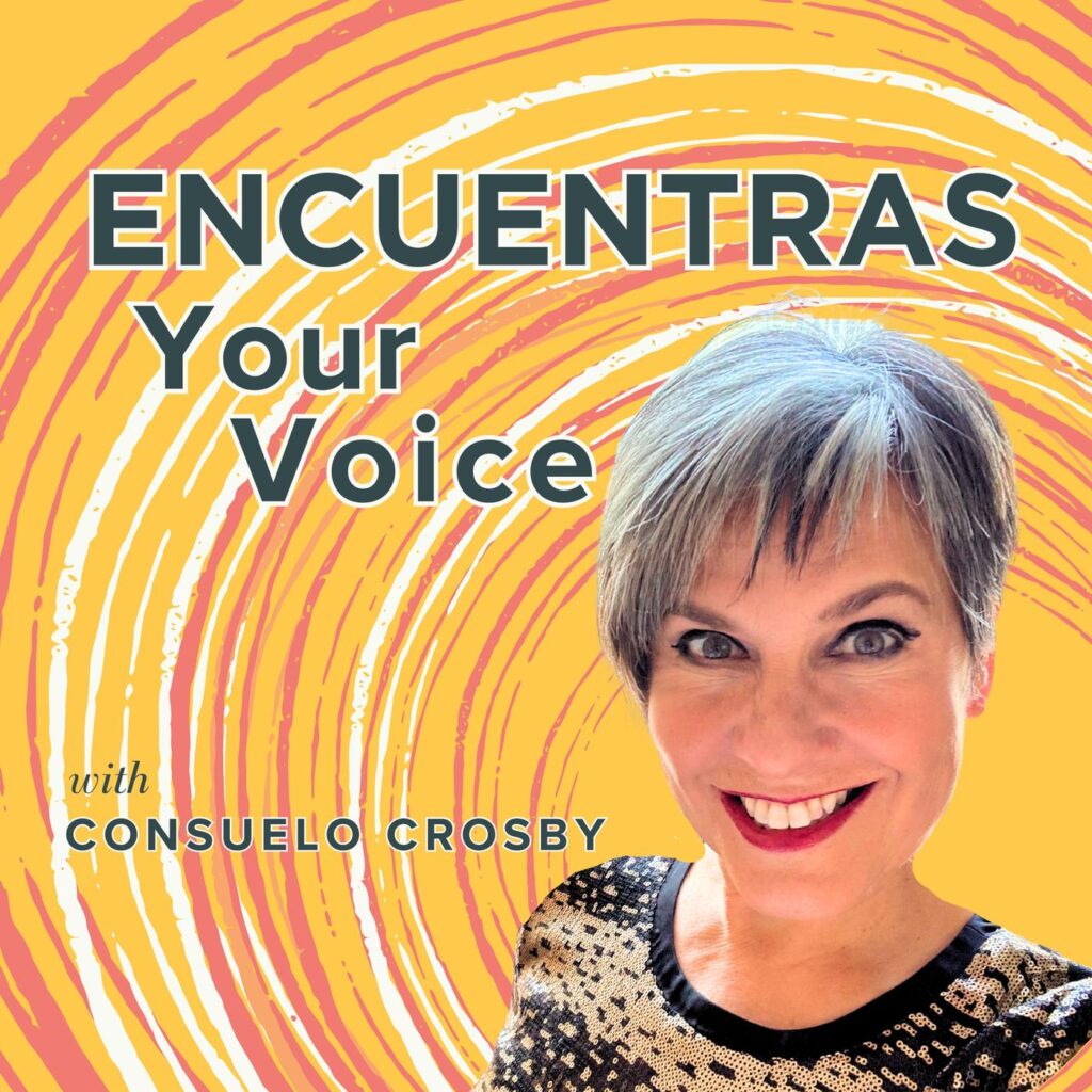 Consuelo Crosby with her adorable salt & pepper pixie cut stands in the lower right corner smiling at the camera against a yellow background with orange and white concentric circles seeminly spin around her. The words ENCUENTRAS Your Voice with Consuelo Crosby are a stark contrast in bold black font outlined in white