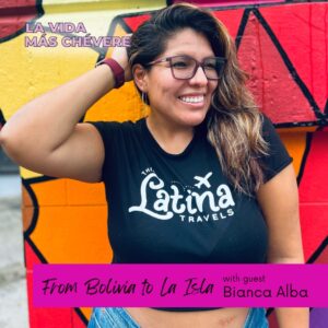 Bianca Alba, a Latina woman with dark hair and glasses, has a hand up to her head as she smiles at something off camera, while standing in front of a brightly colored outside mural. Text on the left corner in bold pink font reads La Vida Más Chévere. In a pink box at the bottom the words read From Bolivia to Boricua with guest Bianca Alba