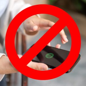 Red cross out over an image of a phone held in a hand, showing the Spotify logo